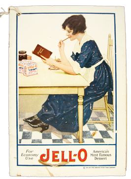 Jell-O booklet cover. Woman sitting at table reading cooking booklet.