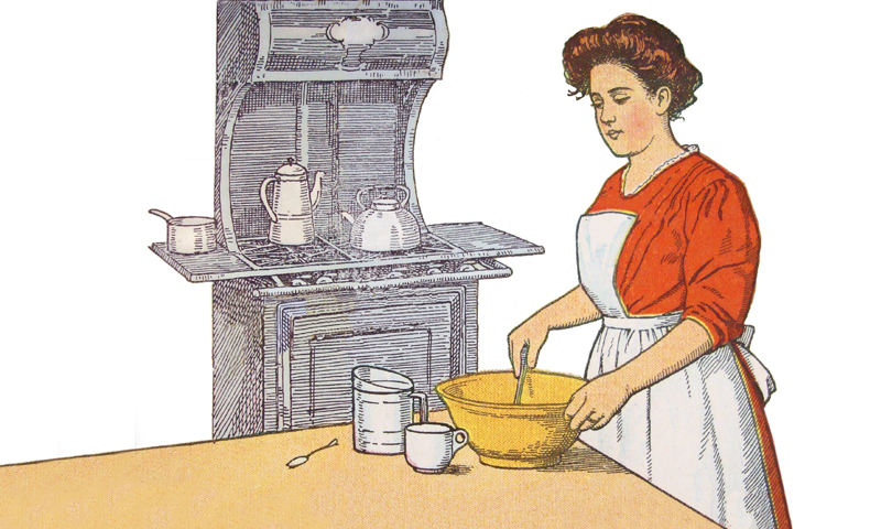 Woman in red dress and apron in kitchen baking with Victorian wood-burning stove in background