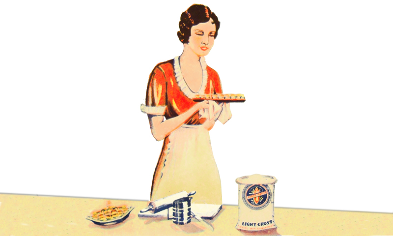 woman in kitchen holding a pie she just baked.