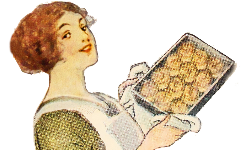 woman holding up a pan of biscuits.