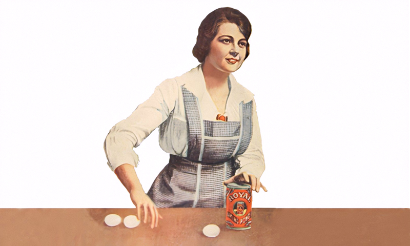 Woman at kitchen counter with chicken eggs and baking powder.