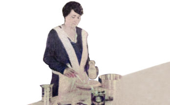Mrs. Louise P. Lillard of Cincinnati, owner of Snow King Baking Powder company standing at counter with ingredients, mixing batter in a bowl.